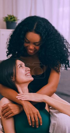 Photo for Young woman and her girlfriend spending time together at home. Lesbian couple love moments happiness concept. - Royalty Free Image
