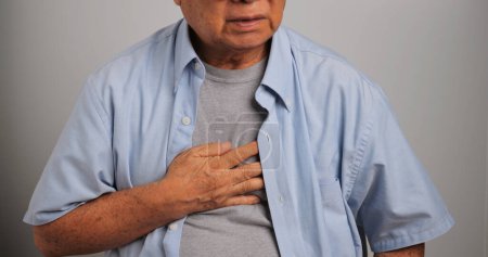 Photo for Asian old man has difficulty breathing. An elderly man has dyspnea. - Royalty Free Image