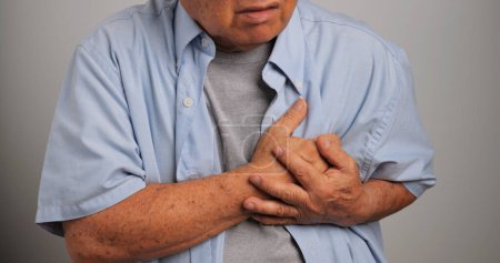 Photo for An elderly man is suffering from heart disease. Old Asian man having heart problems. - Royalty Free Image