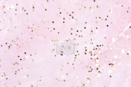 Photo for Pink fluffy feathers with gold glitter Easter festive background - Royalty Free Image