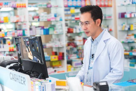 Photo for Professional pharmacist asian man smiling at counter using digital tablet for check medicine inventory in drug store, Medical service online, Telemedicine to giving medical information to patient. - Royalty Free Image