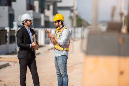 Photo for Professional civil engineer and architect in safety helmet hard hat working together in construction site, two men discuss about real estate project or production in industry - Royalty Free Image