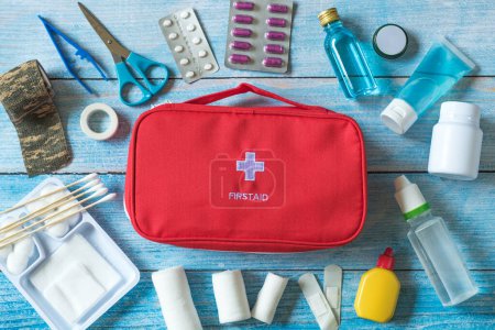 Photo for First aid kit with medical equipment and emergency objects at home or travel set ,copy space,top view,flat lay on wood background - Royalty Free Image