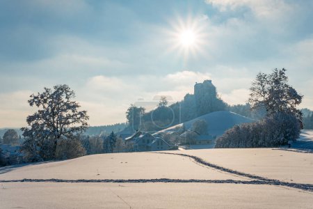 Photo for Snowy and beautiful winter landscape in Waldburg in Upper Swabia. View to the snow-covered castle - Royalty Free Image