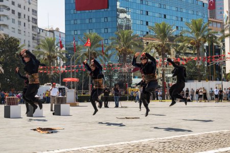 Photo for Izmir, Turkey - September 9, 2022: Group of young people performing zeybek dance at the Republic Square in Izmir Turkey and on the liberty day of Izmir. - Royalty Free Image