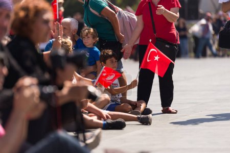 Photo for Izmir, Turkey - September 9, 2022: Crowded people with some kids, kids are waving Turkish flags in a at the celebrations of liberation day Izmir Turkey at the Republic square. - Royalty Free Image
