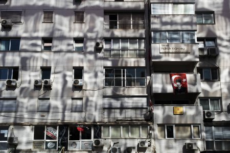 Photo for Izmir, Turkey - September 9, 2022: A building with reflected sunlight from another glass building. - Royalty Free Image