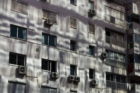 Téléchargez les photos : Izmir, Turquie - 9 septembre 2022 : Un bâtiment avec la lumière du soleil réfléchie d'un autre bâtiment en verre. - en image libre de droit