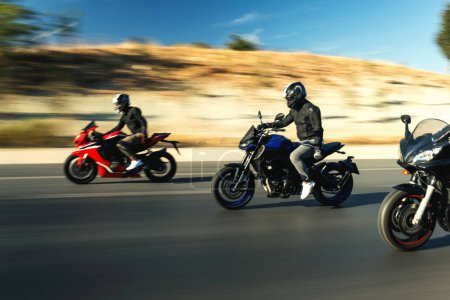 Photo for Three supersport race motorcycle riders going fast side by side on the highway with motion blur. - Royalty Free Image