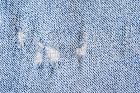 Photo for Close up shot of a blue colored and ripped jeans texture background. - Royalty Free Image