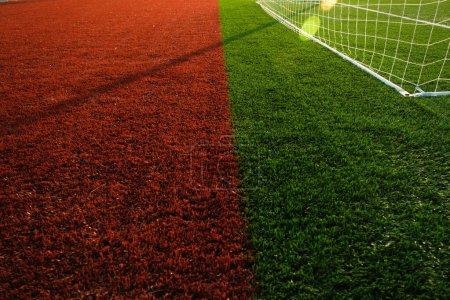 Photo for Close up shot of red and green colored artificial grass in a football pitch - Royalty Free Image