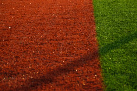 Téléchargez les photos : Close up shot of red and green colored artificial grass in a football pitch - en image libre de droit