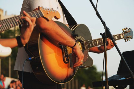 Téléchargez les photos : Close up shot of guitarist playing a guitar on a concert. - en image libre de droit