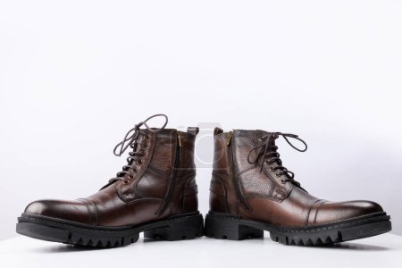 Foto de A pair of brown colored leather boots on a white background. - Imagen libre de derechos