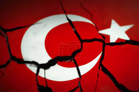 Foto de Turkish flag on a cracked wall aftermath an earthquake. - Imagen libre de derechos