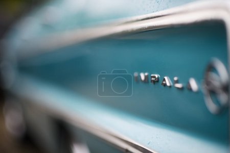 Photo for Izmir, Turkey - June 3, 2023: Close-up shot of the metal Impala logo on a blue classic Chevrolet Impala at the IZKOD Classic Car Meet at Buca Pond - Royalty Free Image