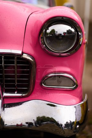 Photo for Izmir, Turkey - June 3, 2023: Focused close-up of a single headlight on a pink 1955 Chevrolet Belair at a classic car event - Royalty Free Image