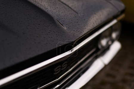 Photo for Izmir, Turkey - June 3, 2023: Close-up of the SS logo on a black Chevrolet Chevelle, adorned with raindrops - Royalty Free Image