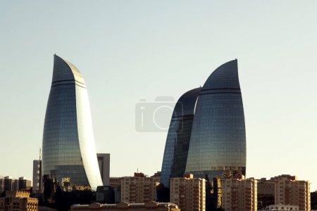 Photo for Baku, Azerbaijan - June 25, 2023: An evening shot of the iconic Flame Towers basking in the golden sunlight - Royalty Free Image