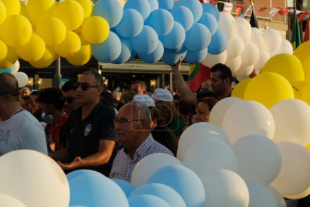 Photo for Izmir, Turkey - September 1, 2023: Crowds with flags from various countries gather under colorful balloons during the Izmir International Fair opening procession - Royalty Free Image