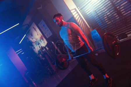 Athlete perfecting the deadlift in a mystical gym ambiance, with blue and red lighting cutting through the mist