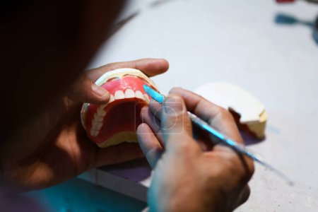 Photo for Close up of prosthetic dental craftsmanship, showcasing the detailed work of creating a dental prosthesis - Royalty Free Image