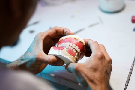 Photo for Close up of prosthetic dental craftsmanship, showcasing the detailed work of creating a dental prosthesis - Royalty Free Image