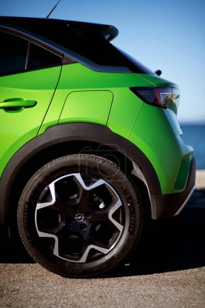 Photo for Izmir, Turkey - December 23 2023: A detailed shot of the rear side and wheel of a green 2022 Opel Mokka, highlighting its design and contours. - Royalty Free Image