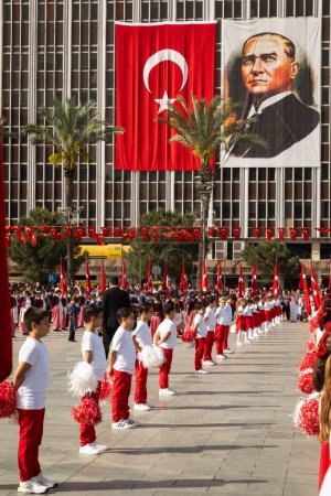 Photo for Izmir, Turkey - April 23, 2024: Celebrating National Sovereignty and Children's Day, children in festive attire stand in solemn respect at Republic Square, Izmir, with the Turkish flag and Ataturk's image prominent - Royalty Free Image