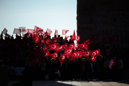 Photo for Canakkale, Turkey - Mar 18 2024: Photo of people holding Turkish flags at the location of the Martyrs' Memorial in Seddulbahir village, celebrating the 18 March Canakkale Victory. - Royalty Free Image