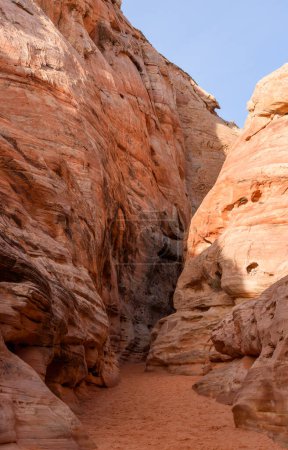 Entrance to a beautiful narrow slot canyon with tall pink sandstone walls, known as Kaolin Wash or Canyon - Valley of Fire State Park, Nevada, USA