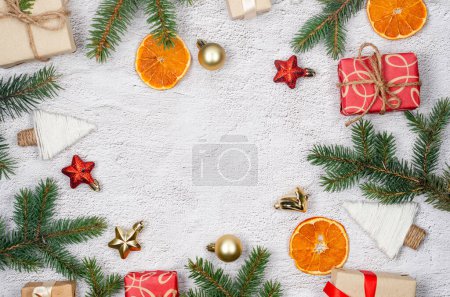 Photo for Christmas and New Year holiday background. Xmas greeting card. Christmas gifts boxes wrapping in craft paper and pine branches on conkrete background top view. Noel. - Royalty Free Image
