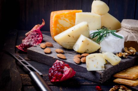 Photo for Assorted homemade pieces cheese with honey, fruits, cookies and nuts on table.  Fresh dairy product, healthy organic food. Delicious appetizer. - Royalty Free Image