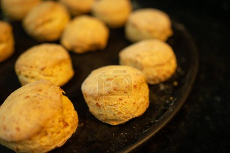 Photo for Close-up of Delicious Freshly Baked Cheese Scones on a Black Background - Royalty Free Image