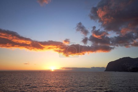 Photo for Beautiful sunset in Madeira, sun, clouds and sea. Summer holiday wallpaper. - Royalty Free Image