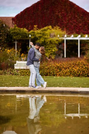 lovely young couple kissing outdoors in autumn. Loving couple walking in nature. Autumn mood. Happy man and woman hugging and kissing in autumn. Love. Fashionable couple outdoors. Fashion, people and