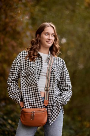 Autumn Elegance: Girl with Warm Tones, Casual Style, and a Park Stroll. ashion trends, autumn style, casual elegance, outdoor fashion, trendy accessories, park lifestyle, cozy vibes, seasonal warmth
