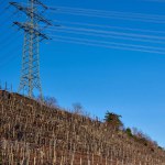 Witness the harmonious blend of technology and nature as power lines stand proudly on a hill, overlooking the picturesque scenery of autumn in Germany. The tranquil villages, vineyards, and riverside