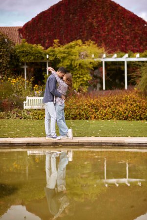 lovely young couple kissing outdoors in autumn. Loving couple walking in nature. Autumn mood. Happy man and woman hugging and kissing in autumn. Love. Fashionable couple outdoors. Fashion, people and