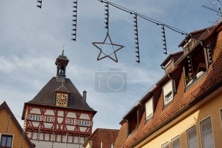 Festive Bietigheim-Bissingen: City Hall, New Year Decorations, Rooftops, Half-Timbered Houses. Discover the enchanting beauty of Bietigheim-Bissingen as the City Hall stands adorned with New Year