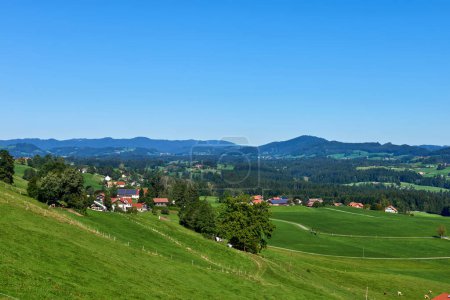 Alpine Foothills Charm: Rural Mountainside Living with Farmers Homesteads. Mountain Countryside Serenity Captured: Farmers Dwellings, Pastures, and the Sky Above. Natures Tapestry Defined: Eco