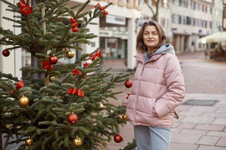 Elegance in the Old Town: Beautiful Woman Posing amidst the Festive Streets of Bietigheim-Bissingen, Germany . A beautiful girl stands on the street of the old European town of Bietigheim-Bissingen in
