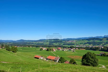 Alpine Foothills Charm: Rural Mountainside Living with Farmers Homesteads. Mountain Countryside Serenity Captured: Farmers Dwellings, Pastures, and the Sky Above. Natures Tapestry Defined: Eco