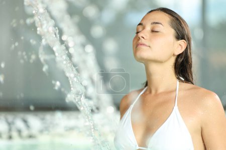 Photo for Beautiful woman relaxing and breathing in spa pool - Royalty Free Image