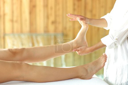 Téléchargez les photos : Close up of a woman receiving a reflexotherapy massage on foot in spa - en image libre de droit