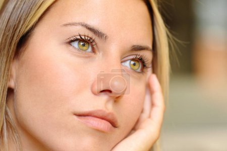 Photo for Close up of a distracted woman with beautiful eyes looking away - Royalty Free Image