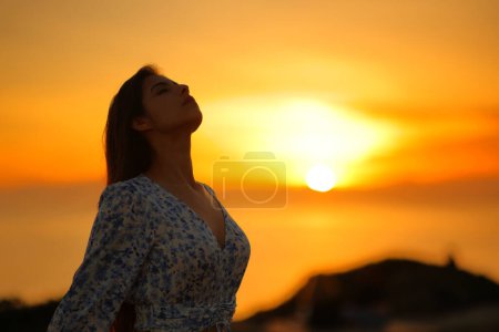 Photo for Relaxed woman breathing fresh air on the beach at sunrise - Royalty Free Image
