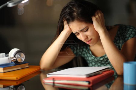 Photo for Sad student trying to learn in the night at home - Royalty Free Image
