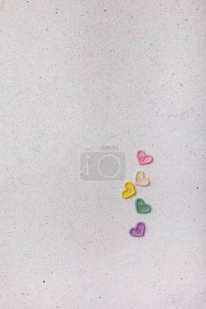 Photo for Multicolored decorative heart-shaped buttons on white background. Ornamental details for sewing, scrapbooking, handmade - Royalty Free Image