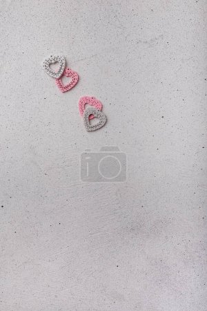 Photo for Four decorative pink heart-shaped buttons on white background. Ornamental details for sewing, scrapbooking, handmade - Royalty Free Image